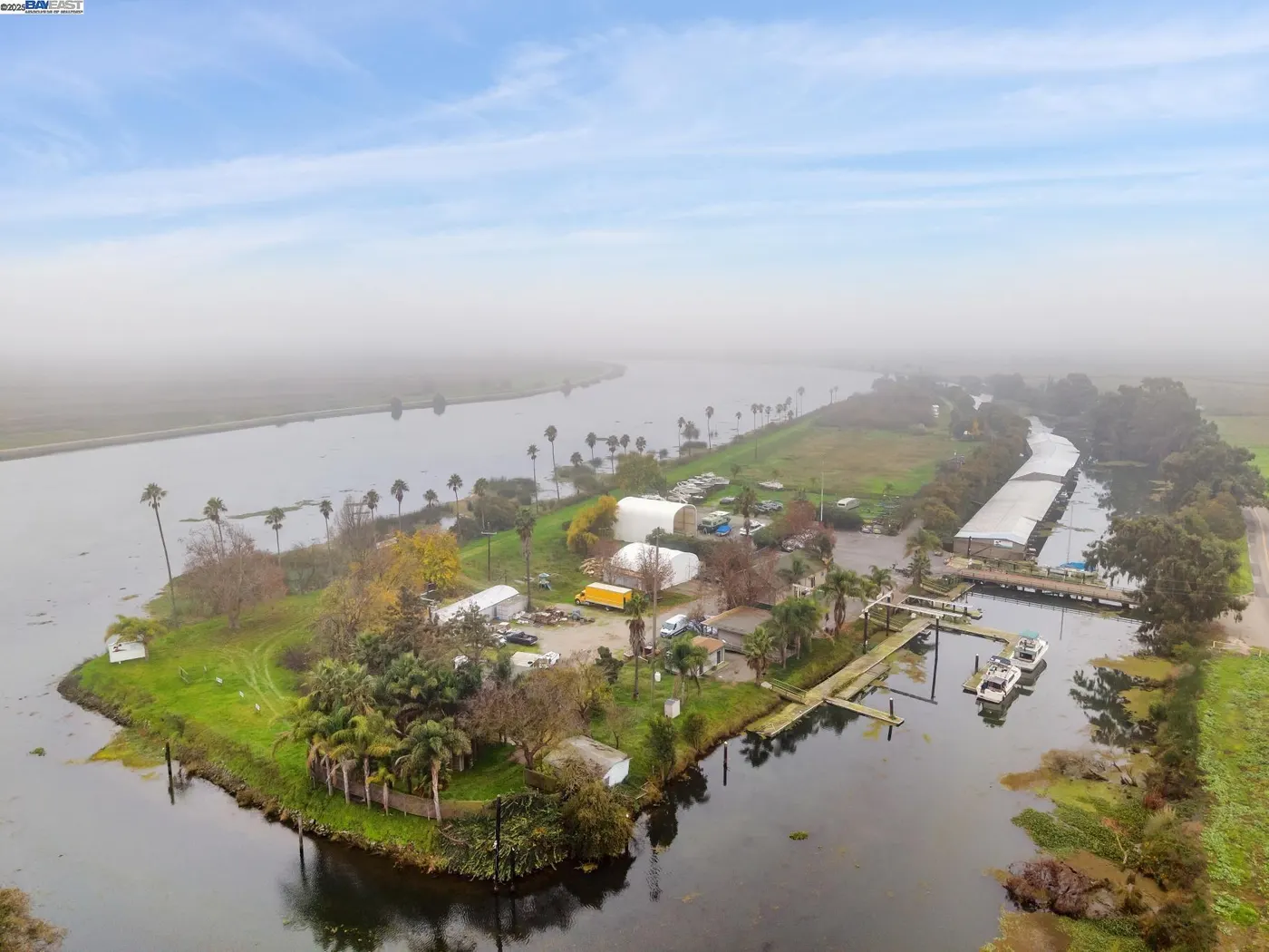 Aerial view of marina and waterways with boats and palm trees